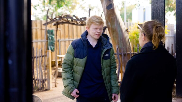 Two people having a conversation outdoor in a park