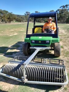 Tim collecting golf balls from the driving range and surrounding scrub areas using a “gator” fitted with a ball collection device.