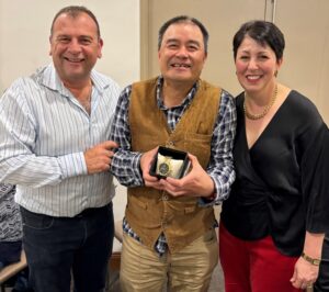 Ling receives a gold watch from Joe and Antonetta Quinzi in recognition of 25 years of service at Quinzi’s Confectionery.